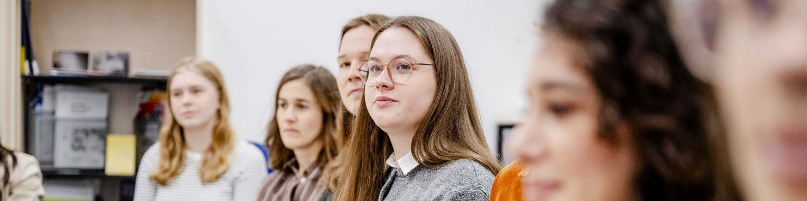 Personen in Meeting-Situation hören aufmerksam zu